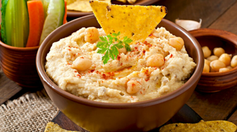 Healthy homemade  hummus with olive oil and pita chips